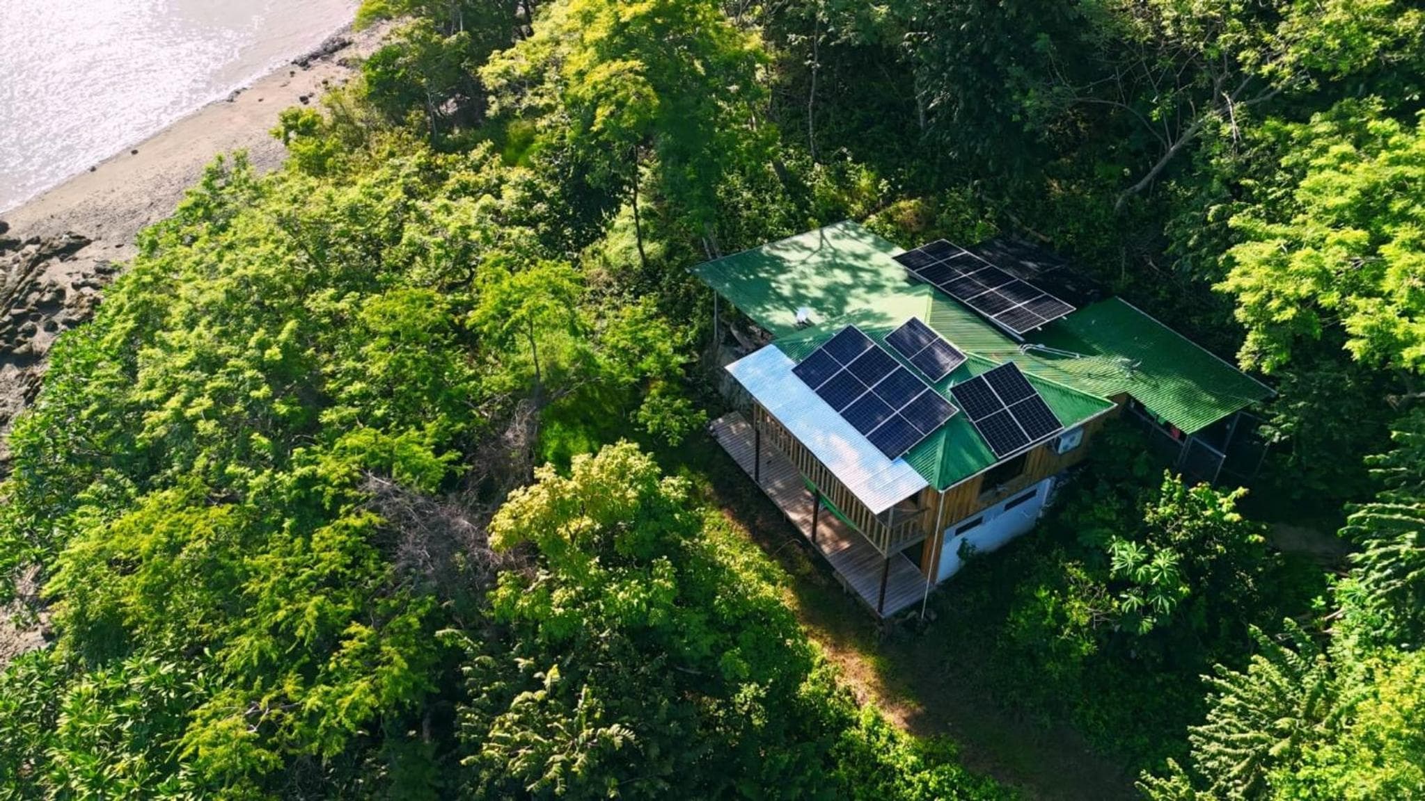 Teak house in a forest above the beach